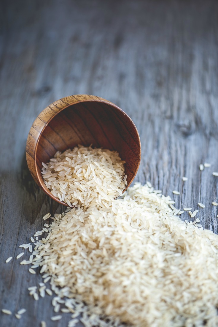 Close-up view of rice bowl on rustic wooden table, shallow DOF